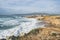 Coastline with atlantic ocean in Cascais, Portugal. Waves at the shore and rocky hills