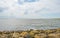 Coastline of basalt stones along a lake in sunlight