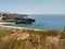 Coastline with beach and buildings near Cabo Carvoeiro in daylight, Peniche