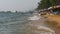 Coastline of the beach. People bathe in the sea, water rides, wave beat on the sandy shore. Thailand. Pattaya.