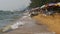 Coastline of the beach. People bathe in the sea, water rides, wave beat on the sandy shore. Thailand. Pattaya.