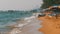 Coastline of the beach. People bathe in the sea, water rides, wave beat on the sandy shore. Thailand. Pattaya.