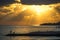 Coastline with beaches, breakwaters and people silhouette on the background of a bright sunset