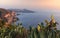Coastline with cactus of island Lipari with view to volcan island Vulcano during sunset, Sicily Italy