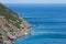 Coastline with cliff mountain and seashore view. Pitched rock face on the sea. Elba island in Italy. Aerial view. Green vegetation