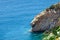 Coastline with cliff mountain and seashore view. Pitched rock face on the sea. Elba island in Italy. Aerial view. Green vegetation