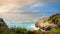 Coastline with cliffs, turquoise water and sailboat, sunrise, Mallorca, Spain