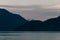 Coastline in the evening with mountain glowing in the background