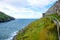 Coastline with green grass and great wall of Peel Castle in Peel, Isle of Man
