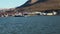 Coastline with houses and dock in ocean of Arctic.