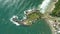 Coastline with island, beach and ocean with waves in Brazil. Aerial view of Matadeiro Beach and Ponta das Campanhas island