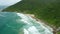 Coastline with mountain, beach and ocean with waves in Florianopolis, Brazil. Aerial view