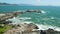 Coastline with rocks and ocean with wave in Brazil. Aerial view of Ponta das Campanhas in Florianopolis