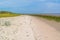 Coastline with sand, grass and mudflat at low tide near Rotterda