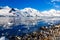 Coastline with stones and cold still waters of antarctic sea lag