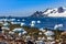 Coastline with stones and ice and cold still waters of antarctic