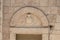 The coat of arms carved in stone on the wall above the entrance to the Deir Al-Mukhraqa Carmelite Monastery in northern Israel