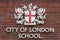 Coat of arms of City of London on facade of City of London School, London, United Kingdom