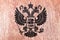 the coat of arms of the city of Moscow in the middle of the two-headed eagle of black color on a wooden surface