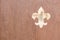 Coat of arms fleur de iys sign on rustic wood background