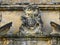 Coat of arms gargoyle Bolsover Castle weathered exterior wall and grounds