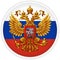 The coat of arms of the Russian Federation against the background of the flag in the form of a round sticker.