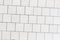 Coating with modern textured paving tiles of square shape. White square paving slabs interspersed with natural stone. Sample of