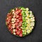 Cobb Salad on black plate on dark slate backdrop. American cuisine dish with tomatoes, chicken, bacon, eggs, cheese, avocado and