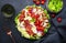 Cobb salad with chicken fillet, tomatoes, eggs, bacon, avocado and lettuce, dark table background, top view. American cuisine dish