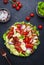 Cobb salad with chicken fillet, tomatoes, eggs, bacon, avocado and lettuce, dark table background, top view. American cuisine dish