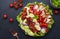 Cobb salad with chicken fillet, tomatoes, eggs, bacon, avocado and lettuce, dark table background, top view. American cuisine dish