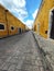 Cobbled sidewalk in Mexico featuring yellow buildings