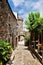 A cobbled street overlooking the towers of La Vila Vella in Tossa de Mar.