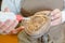 Cobbler applying glue to sole shoe