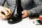 Cobbler s hands cleaning shoes with a brush over his working place