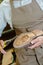 Cobbler using snippers on edge shoe