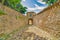 Cobblestone alley under ancient arch