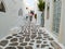 Cobblestone narrow alley whitewashed buildings Mykonos island Cyclades Greece