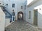 Cobblestone narrow alley whitewashed houses Kythnos island Cyclades Greece