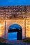 Cobblestone path, fortress gate, and a wooden bridge at twilight inside Kalemegdan fortress in Belgrade