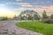 Cobblestone path leading to a dome climbing frame