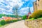 Cobblestone path road to medieval Loket Castle Hrad Loket gothic style building with stone walls, street lights