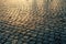 Cobblestone pavement stones at sunset light, old European street background