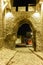 Cobblestone street under ancient fortress entrance of old town of city of Plovdiv, Bulgaria