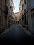 Cobblestone street urban panorama of quaint charming mediterranean village town Pezenas Beziers Herault Occitanie France