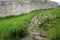 Cobblestone walkway leading to an ancient fortress