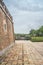 Cobblestone yard around a historic structure with brick walls in Vietnam