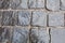 Cobblestones on pavement background, stone sidewalk texture gray or black color, wet bricks road surface pattern top view close up