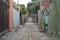 A coble stone alley in suburban melbourne with an old iron fence