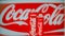 Coca-Cola aluminum can of carbonated soft drink on the background of Coca-Cola brand poster with a can.Russia, Tatarstan, Kazan.